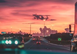 cars on road in sunset