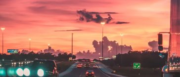 cars on road in sunset