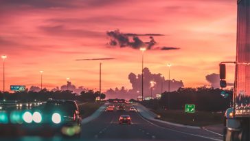 cars on road in sunset