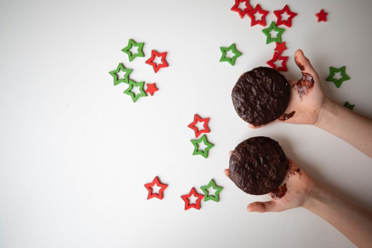 a person holding two cookies in their hands