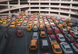 different cars parking near white buildings