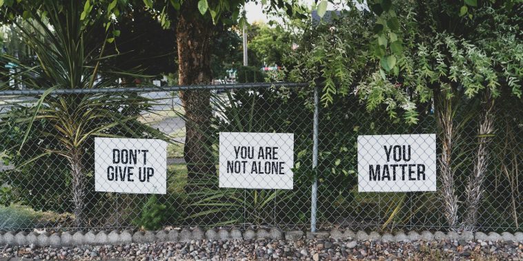 don't give up. You are not alone, you matter signage on metal fence