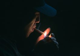man lighting his cigarette
