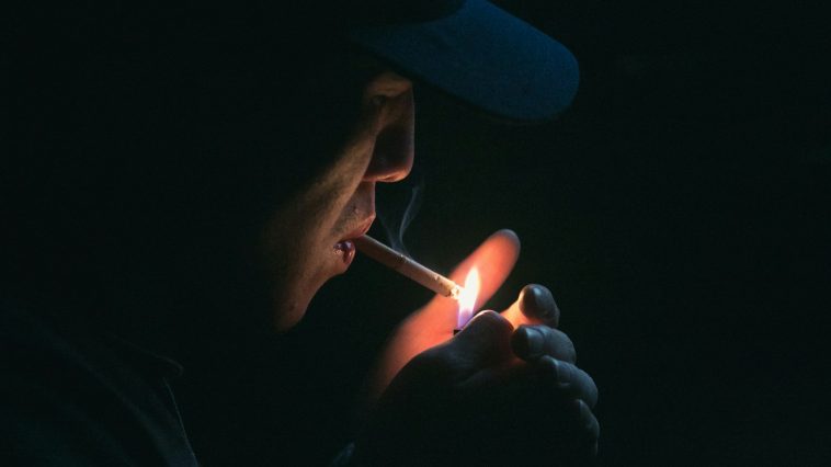 man lighting his cigarette