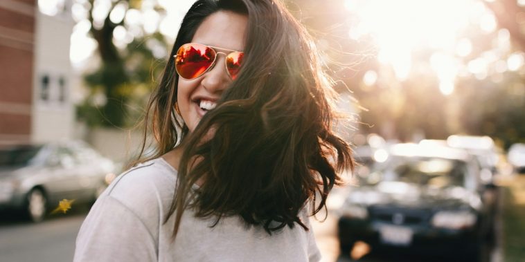 woman wearing white T-shirt smiling
