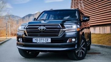 a black toyota land cruiser parked in front of a building