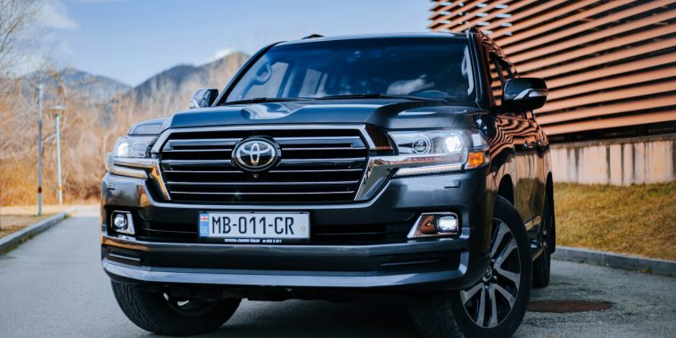 a black toyota land cruiser parked in front of a building