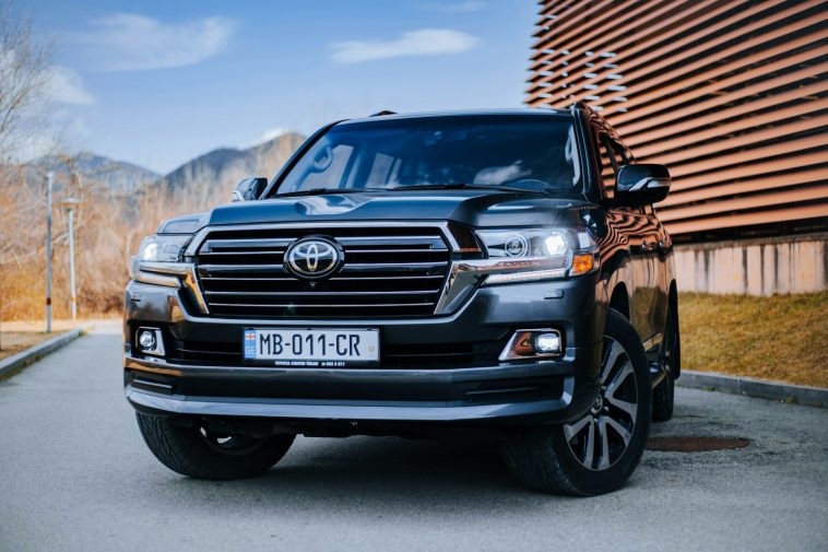 a black toyota land cruiser parked in front of a building