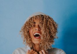 smiling woman wearing gray hoodie