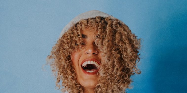 smiling woman wearing gray hoodie