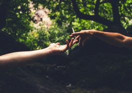two person reaching each others hand