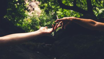 two person reaching each others hand