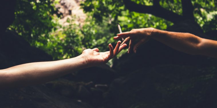 two person reaching each others hand