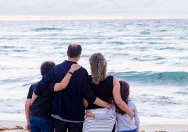 a family of four on a beach