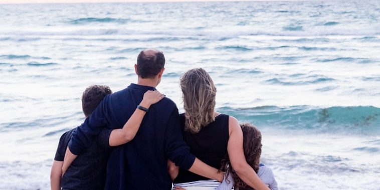 a family of four on a beach