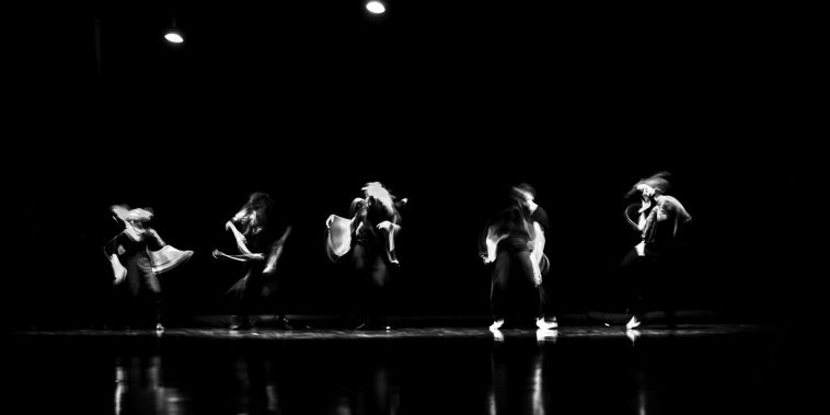 a group of people standing on top of a stage