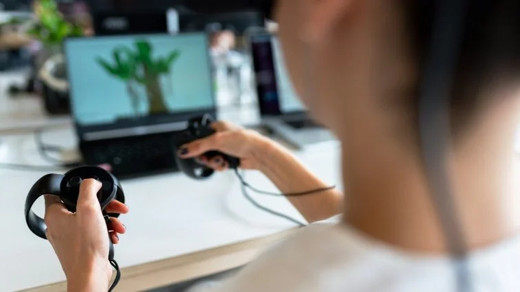 person holding black game controller