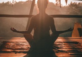 woman doing yoga meditation on brown parquet flooring