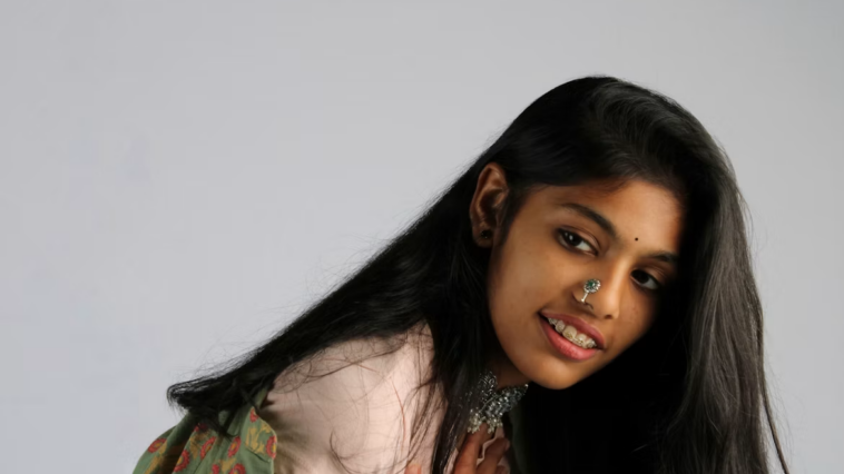 Close-up of a woman with her hair pulled back wearing a delicate nose ring